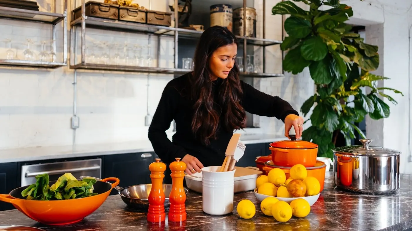 A person preparing fresh food at a kitchen counter