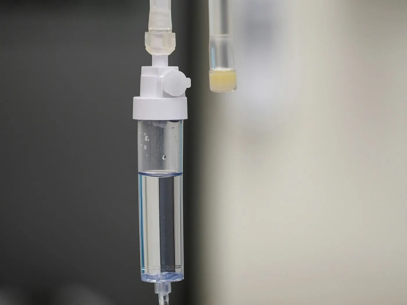 A clear IV fluid bag and giving set prepared for an infusion