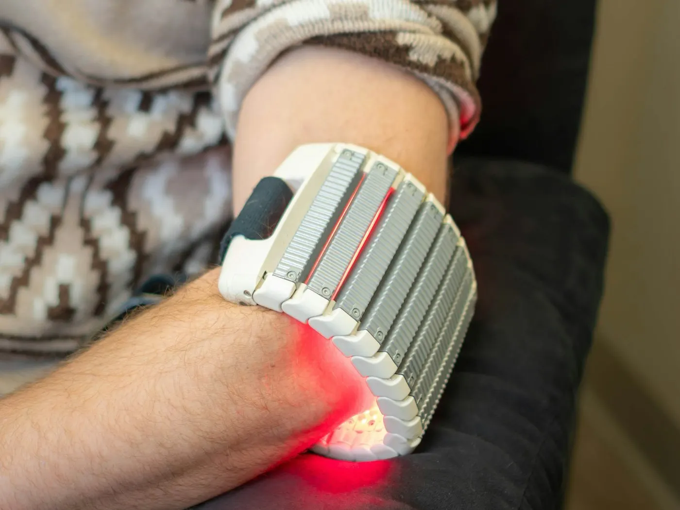 A red light therapy wrap fastened around a patient's wrist and forearm