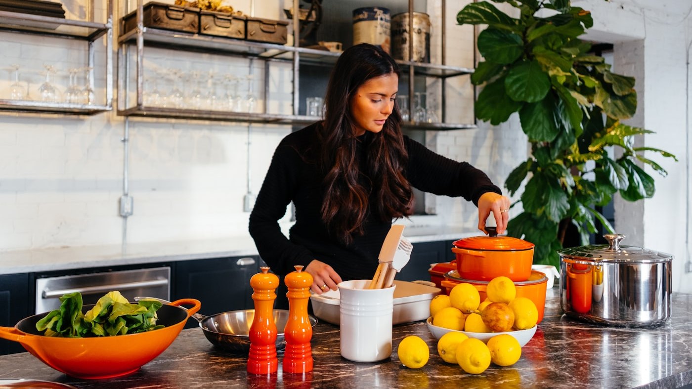 A person preparing fresh food at a kitchen counter