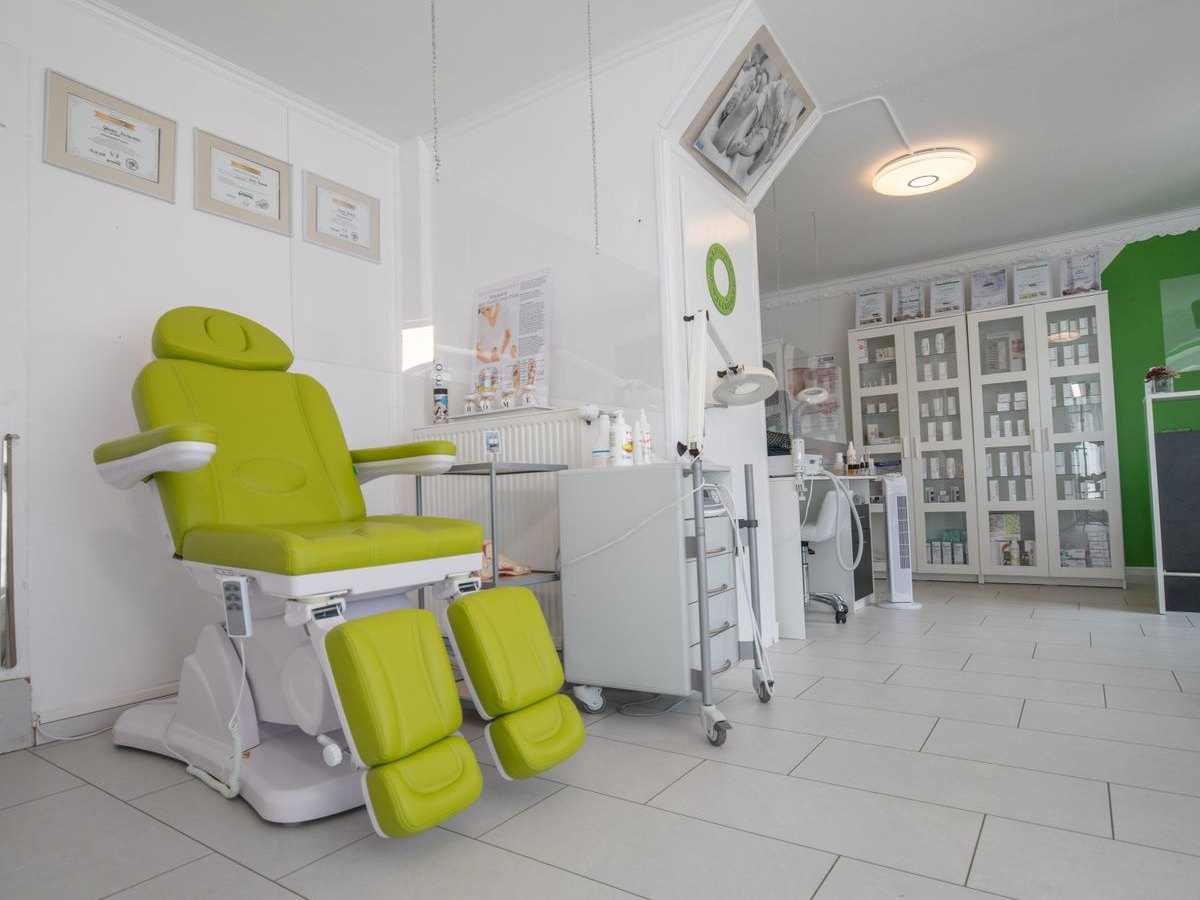 A bright treatment room with a powered treatment chair, ready for the next patient