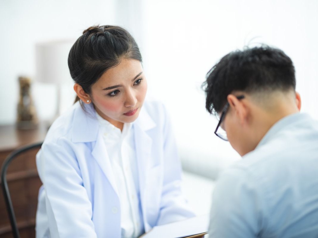 A clinician talking a patient through their options in a consultation