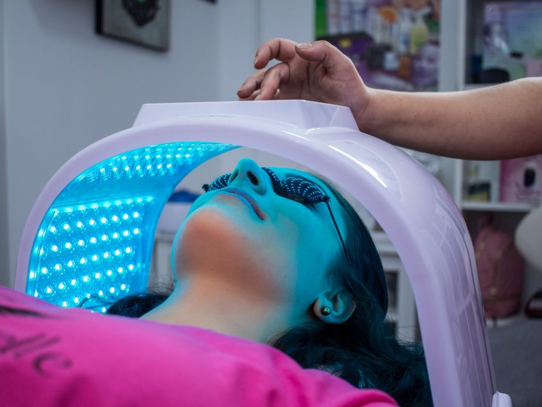 A patient under an LED light therapy panel