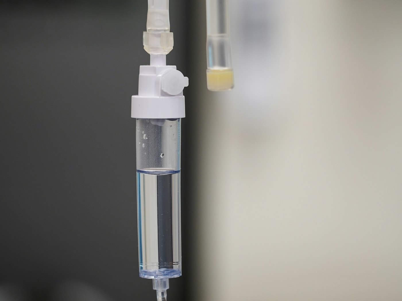A clear IV fluid bag and giving set prepared for an infusion