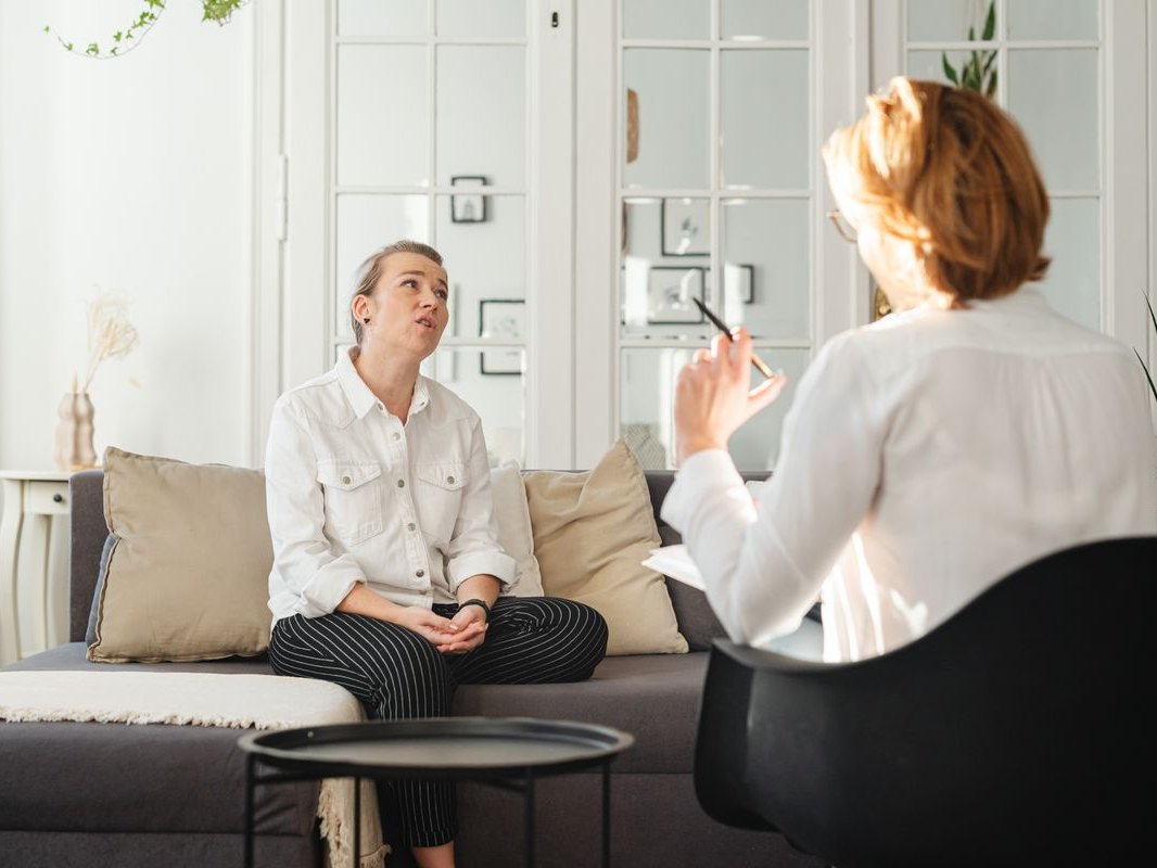 A patient and clinician sitting together in a calm consultation room