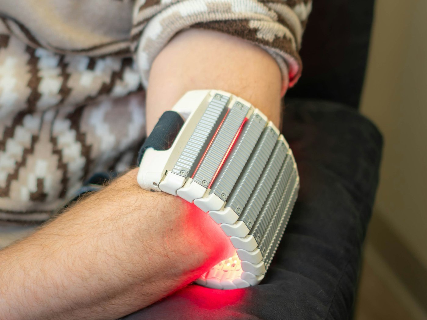 A red light therapy wrap fastened around a patient's wrist and forearm